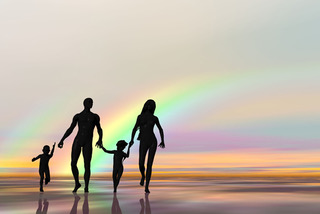 family in front of rainbow